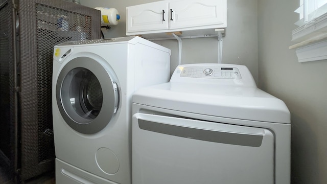 laundry area with cabinet space and washing machine and dryer