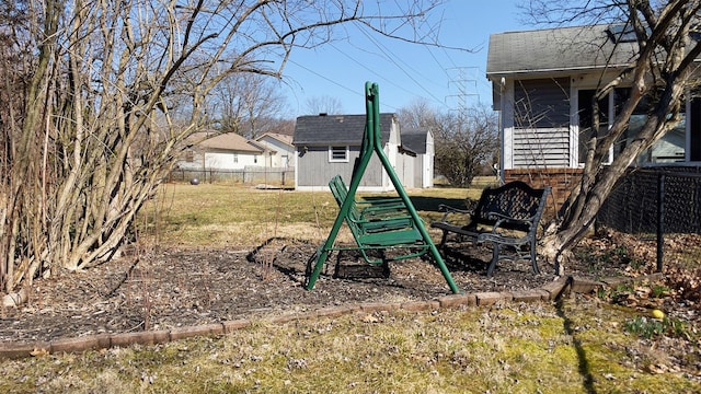 view of yard with a storage unit, an outdoor structure, and fence