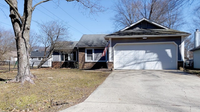 ranch-style home with brick siding, an attached garage, driveway, and fence