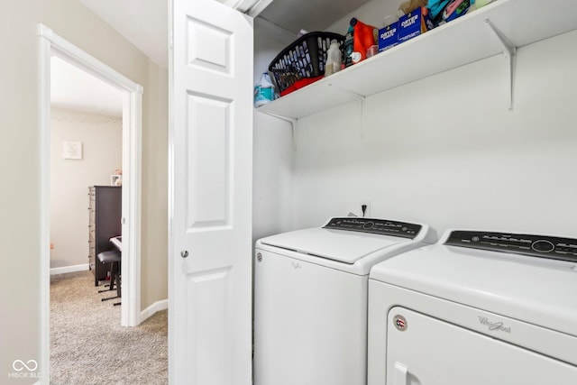 laundry area with washer and dryer, baseboards, light colored carpet, and laundry area