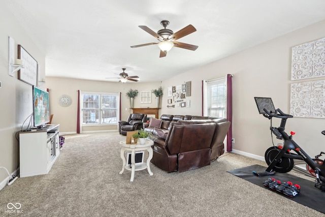 living room featuring carpet flooring, a ceiling fan, and baseboards