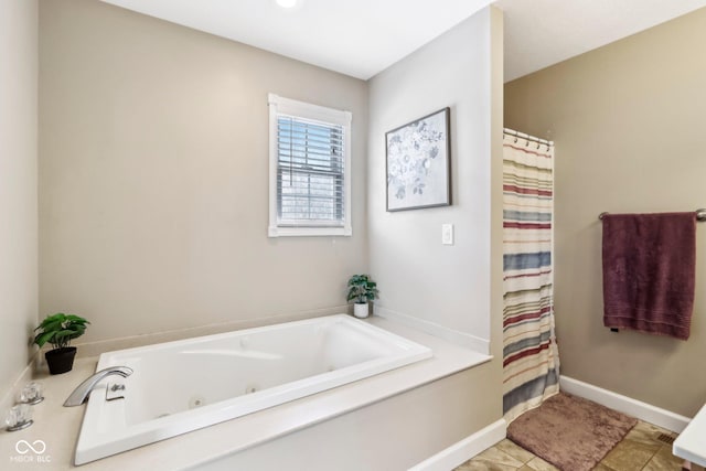 full bath featuring tile patterned flooring, a shower with shower curtain, a jetted tub, and baseboards