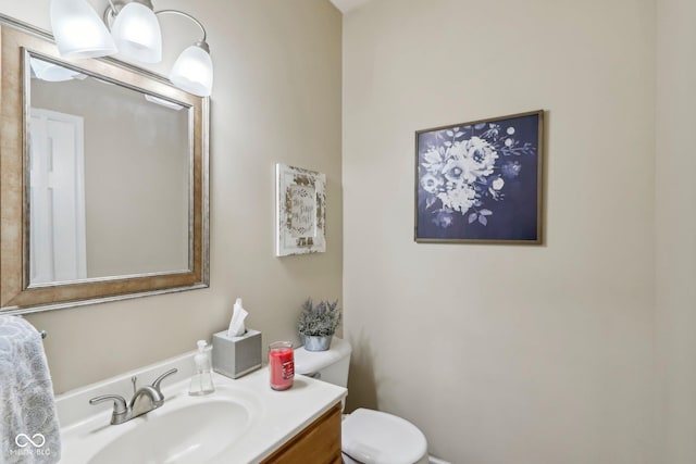 bathroom with toilet and vanity