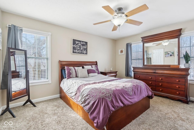 carpeted bedroom featuring baseboards and ceiling fan