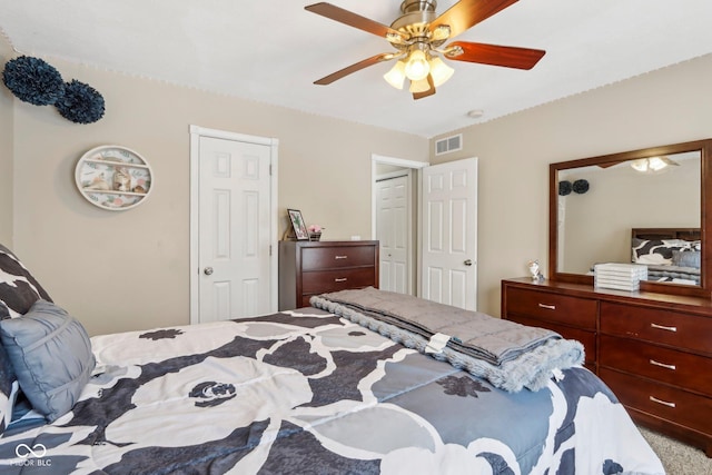 bedroom with visible vents, carpet, and ceiling fan