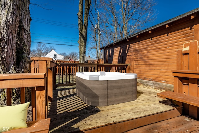 wooden deck with a hot tub