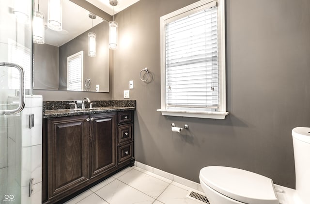 full bathroom with visible vents, an enclosed shower, toilet, baseboards, and vanity