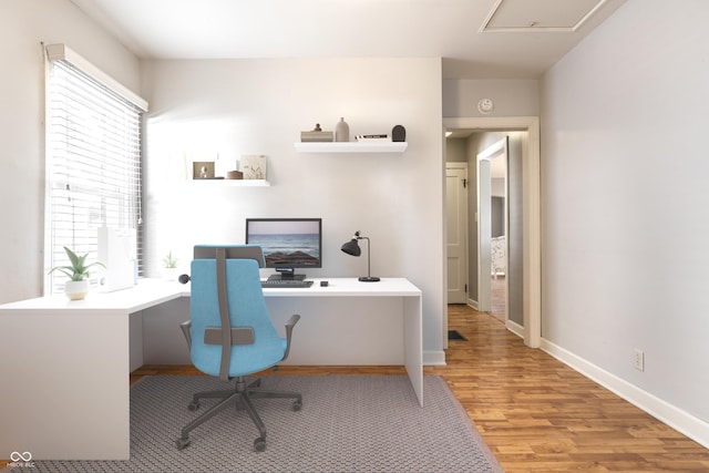 office space featuring baseboards and wood finished floors