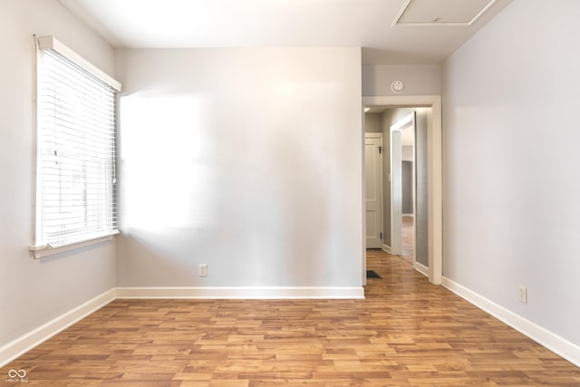 empty room with light wood-style flooring and baseboards