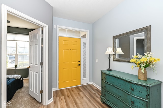 foyer featuring baseboards and light wood finished floors