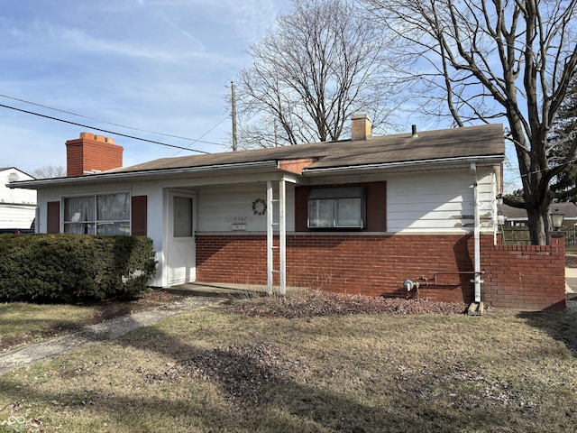 view of front of property with brick siding and a chimney