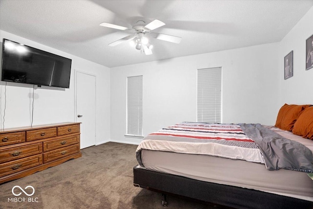 bedroom with ceiling fan, carpet floors, and a textured ceiling