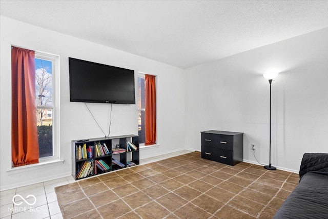 living room featuring tile patterned floors and a textured ceiling