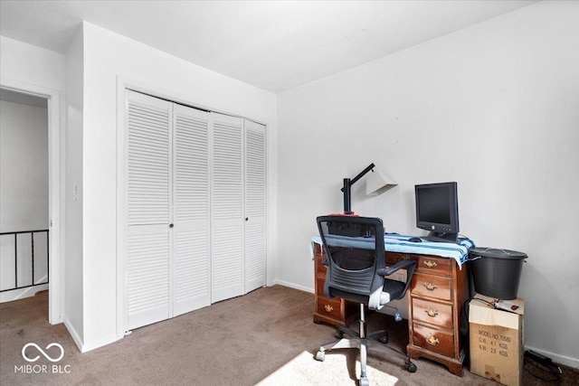 carpeted office space featuring baseboards