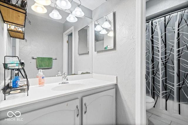 bathroom with vanity, a shower with curtain, toilet, and a textured wall