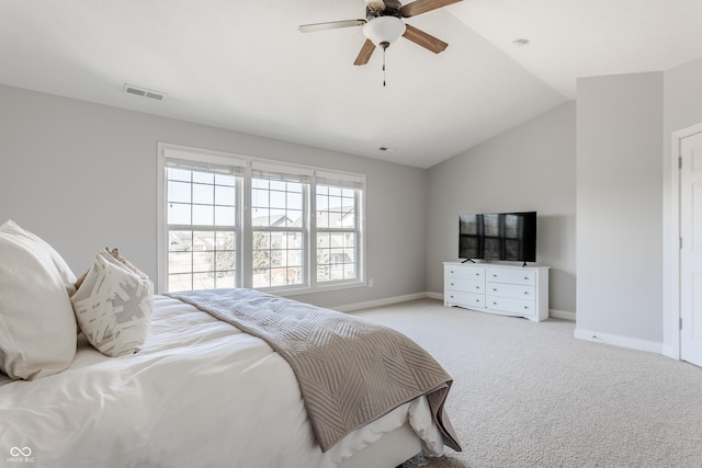 bedroom featuring visible vents, lofted ceiling, light colored carpet, and baseboards