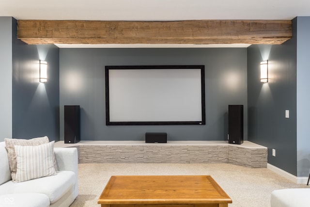 home theater with beamed ceiling, carpet, and baseboards