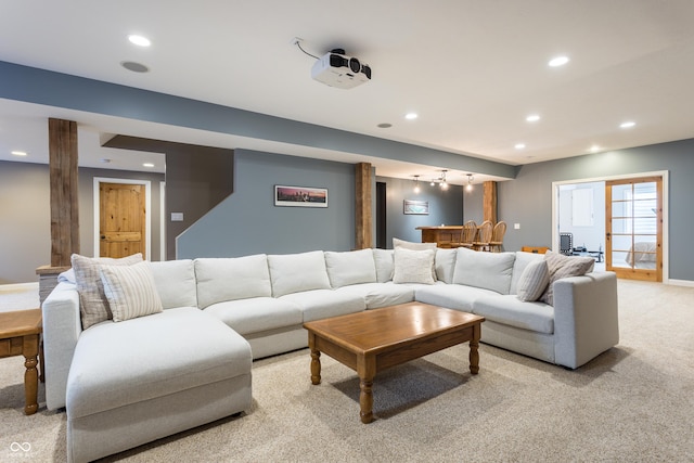 living area with recessed lighting, baseboards, and light carpet