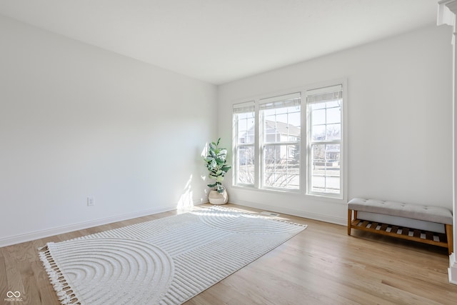 unfurnished room with baseboards and wood finished floors