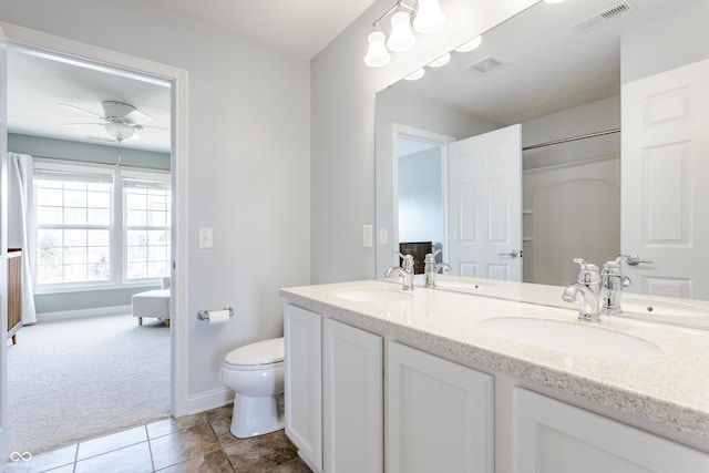 bathroom featuring a sink, visible vents, and toilet