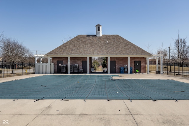 community pool featuring a patio and fence