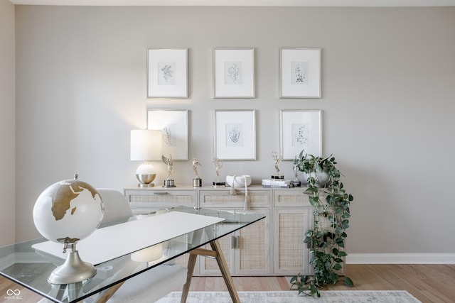 office area featuring light wood finished floors and baseboards