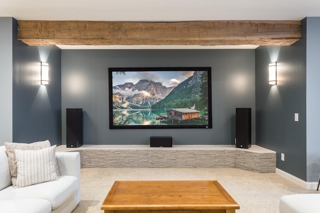 carpeted cinema featuring baseboards and beam ceiling