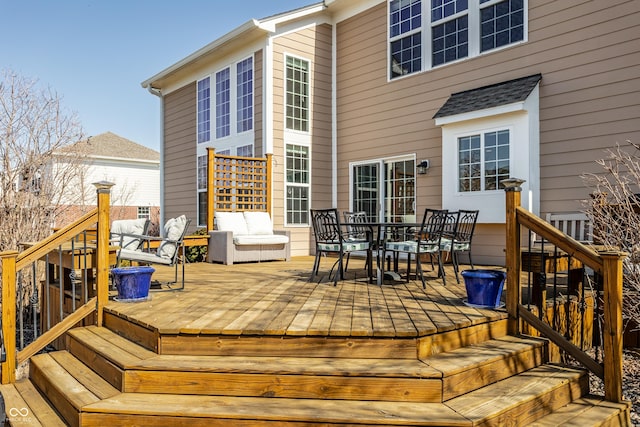 wooden terrace featuring outdoor dining area