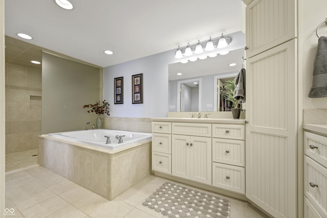 bathroom featuring tile patterned floors, vanity, and a garden tub