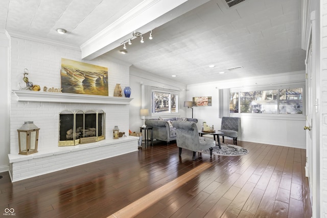 living area with a fireplace, wood finished floors, and crown molding