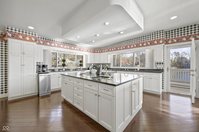 kitchen featuring white cabinetry, a healthy amount of sunlight, and a sink