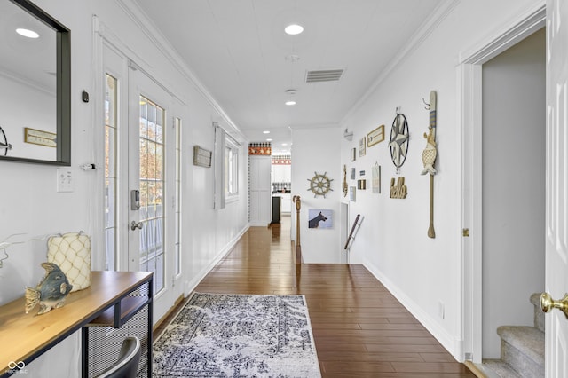 hall featuring visible vents, baseboards, ornamental molding, recessed lighting, and wood finished floors