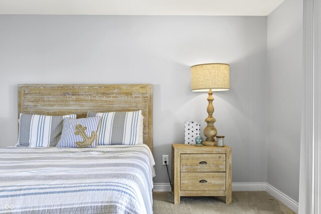 bedroom featuring carpet and baseboards