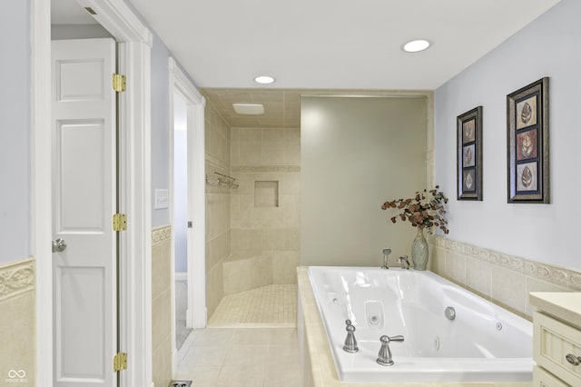 full bathroom with tile patterned flooring, a whirlpool tub, a tile shower, recessed lighting, and vanity