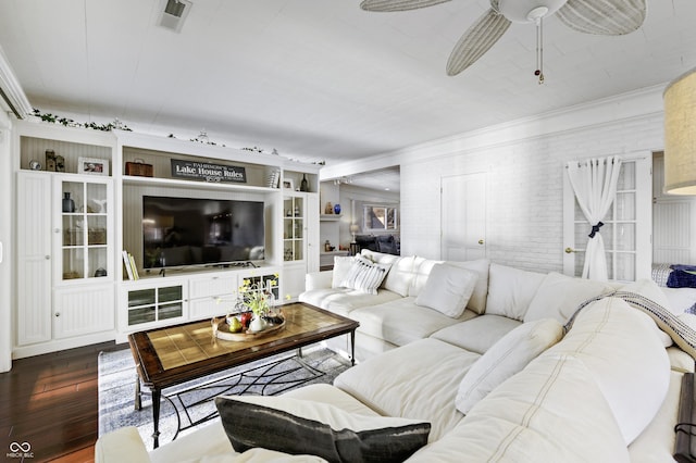 living area featuring visible vents, brick wall, ornamental molding, ceiling fan, and wood-type flooring