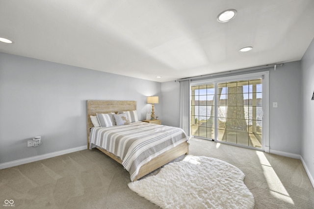 carpeted bedroom with recessed lighting, baseboards, and access to exterior