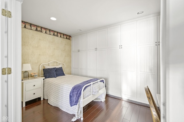 bedroom with dark wood-type flooring and recessed lighting