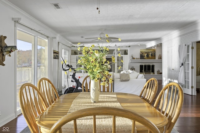 dining room featuring visible vents, ornamental molding, ceiling fan, and hardwood / wood-style floors