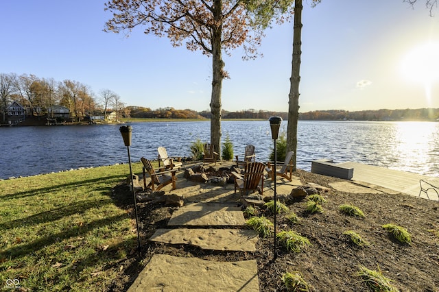 dock area with a yard and a water view