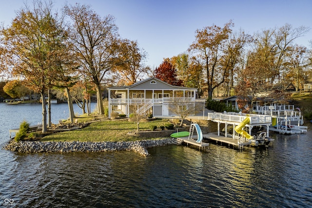 dock area featuring a lawn, a water view, and boat lift