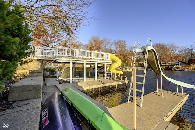 dock area featuring a playground and a water view