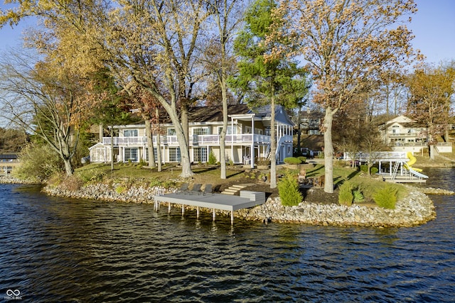 exterior space with a water view and a balcony