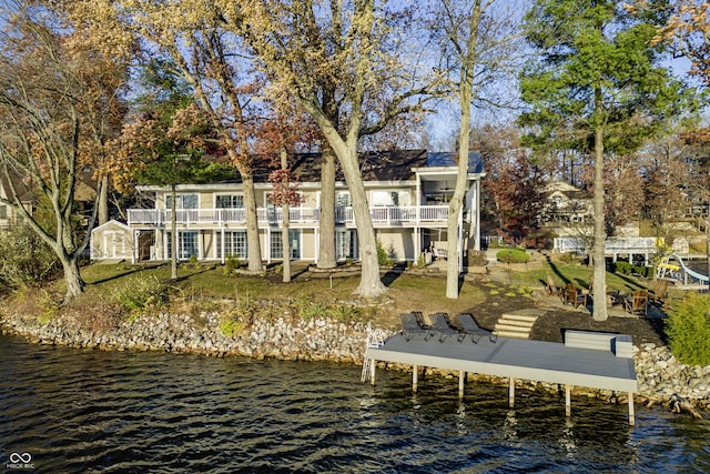 dock area featuring a water view and a balcony