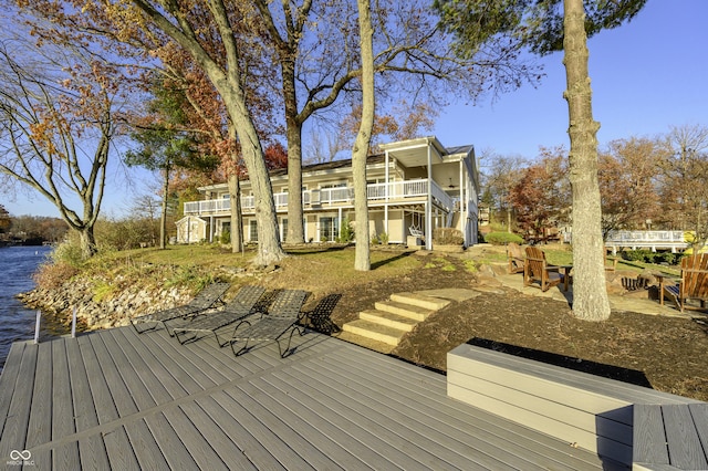 wooden terrace featuring stairway and a water view