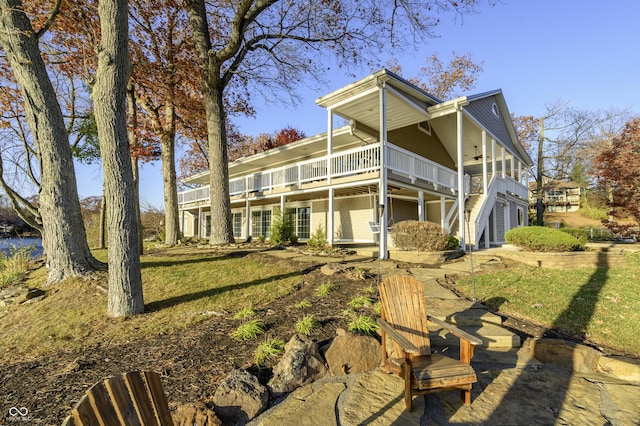 rear view of house featuring stairs and a patio