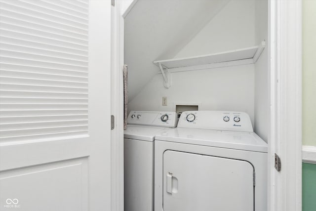 clothes washing area featuring laundry area and washer and clothes dryer