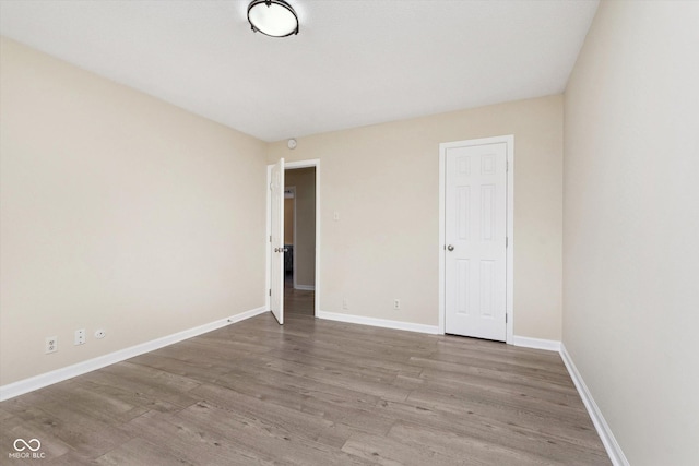 unfurnished bedroom featuring baseboards and wood finished floors