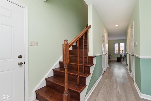 staircase with recessed lighting, wood finished floors, and baseboards