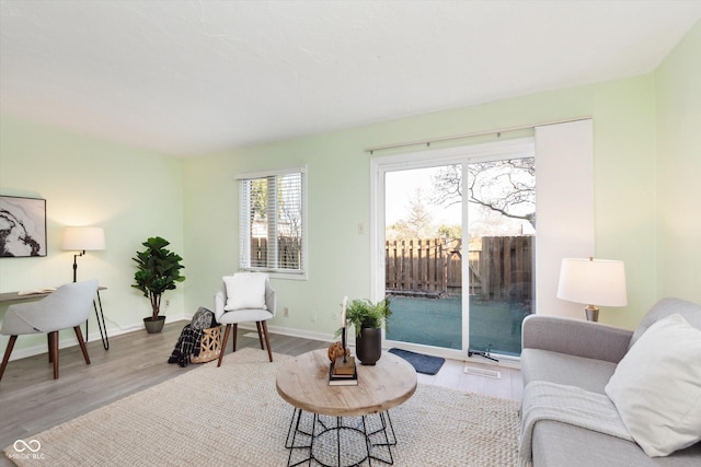 living room with baseboards and wood finished floors