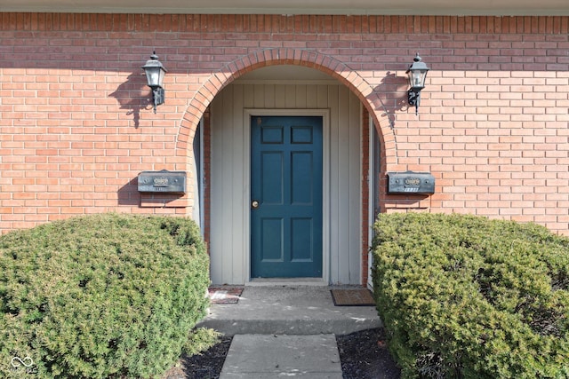 view of exterior entry with brick siding